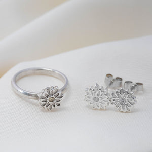 silver flower stud earrings with cubic zirconias and a matching silver flower ring
