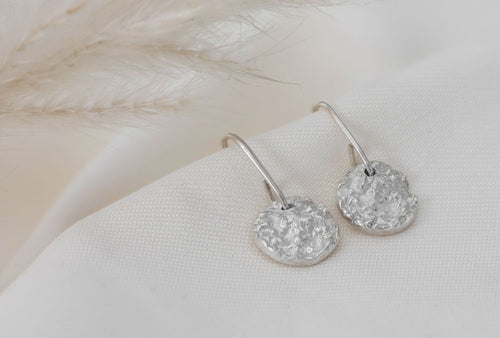Silver circular earrings with a crystal fossil texture