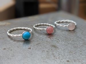 3 rings, all twisted silver bands, one rose quartz, one turquoise, one rhodochrosite
