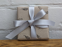 Load image into Gallery viewer, Recycled kraft wrapping paper, with tag and silver ribbon.
