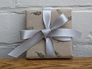 Recycled kraft wrapping paper, with tag and silver ribbon.