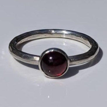 Silver textured band with red garnet cabochon ring