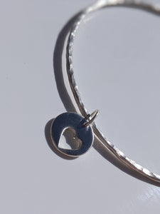 Silver heart charm on a sterling silver hammered bangle