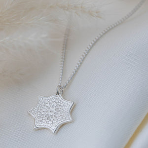 Heptagon shaped silver pendant with flower design 